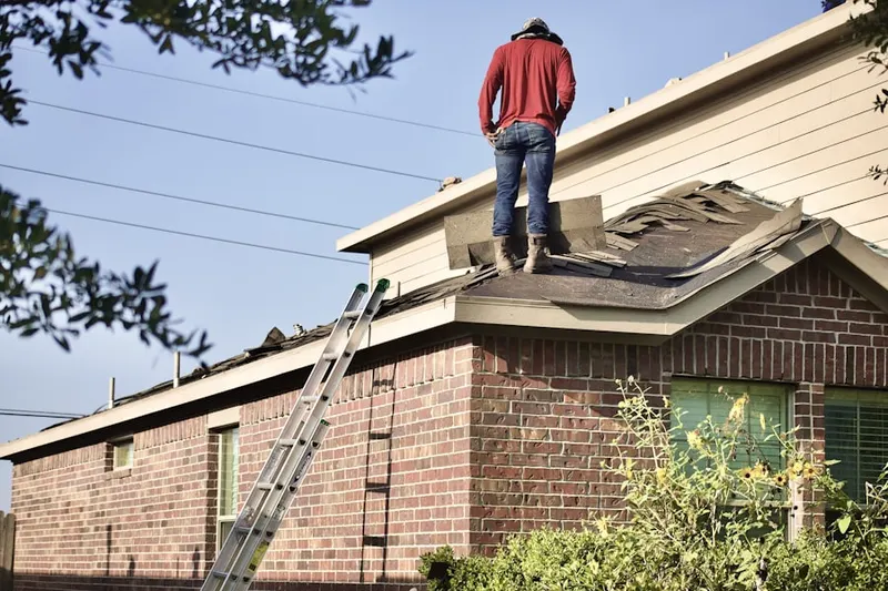 Professional roofer working on a residential roof in O'Hare